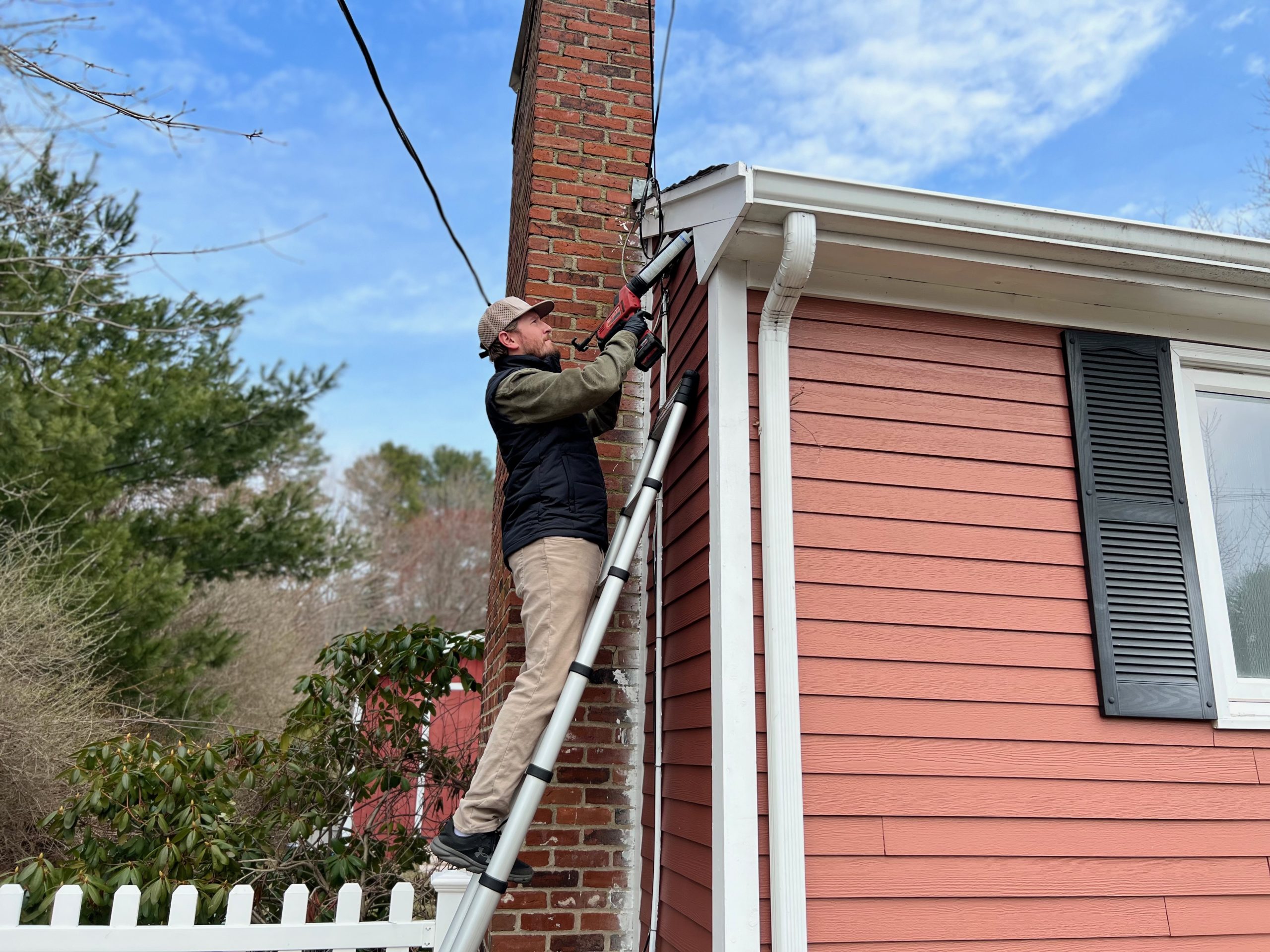 Pest Control Technician Caulking Roofline