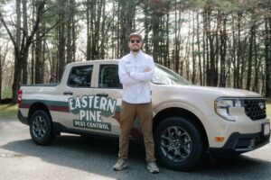Ty in from of pest control truck